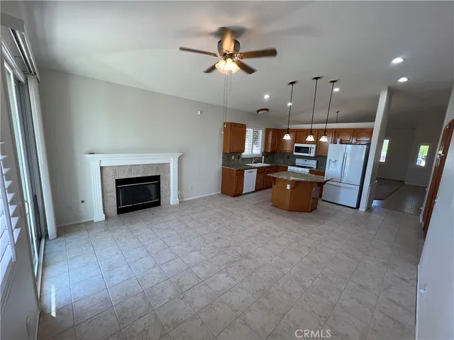 an empty room with fireplace and windows