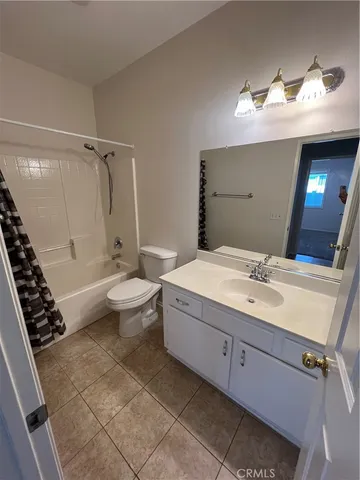 a bathroom with a double vanity sink mirror and toilet