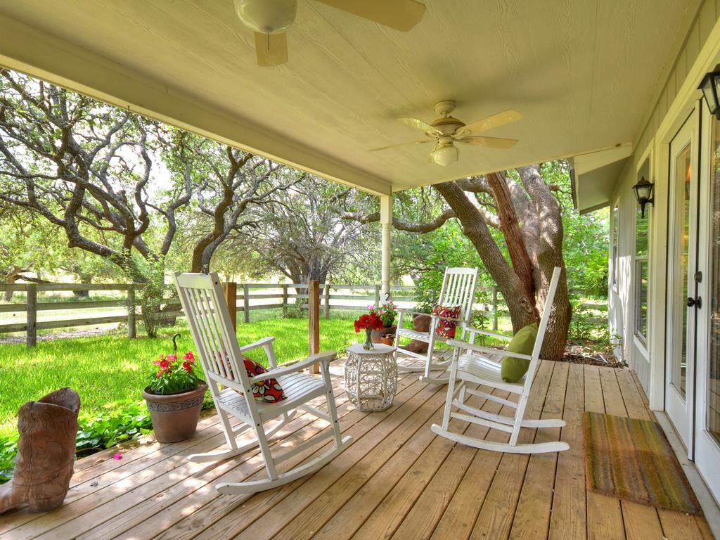 a view of swimming pool with garden and patio