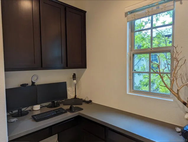 a view of workspace with a window and cabinet