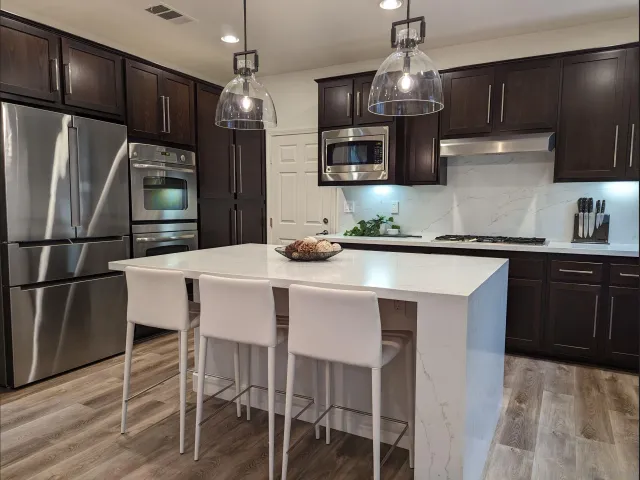 a kitchen with stainless steel appliances a sink stove and refrigerator