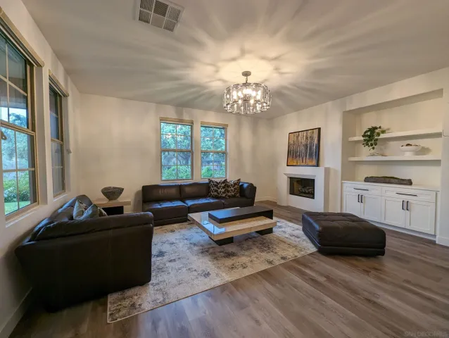 a living room with furniture fireplace and flat screen tv