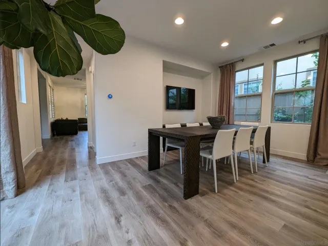 a view of a dining room with furniture window and wooden floor