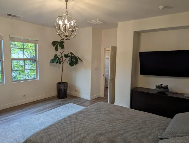 a bedroom with a bed and a chandelier