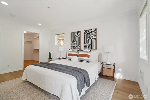 a bedroom with a bed and a night stand