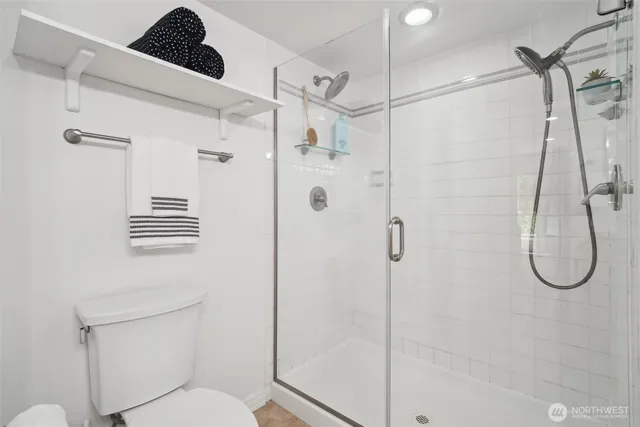 a bathroom with a shower a toilet and sink