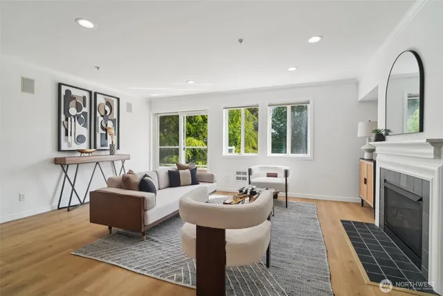 a living room with furniture a fireplace and a table