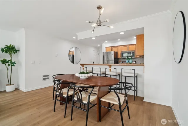 a view of a dining room with furniture and wooden floor