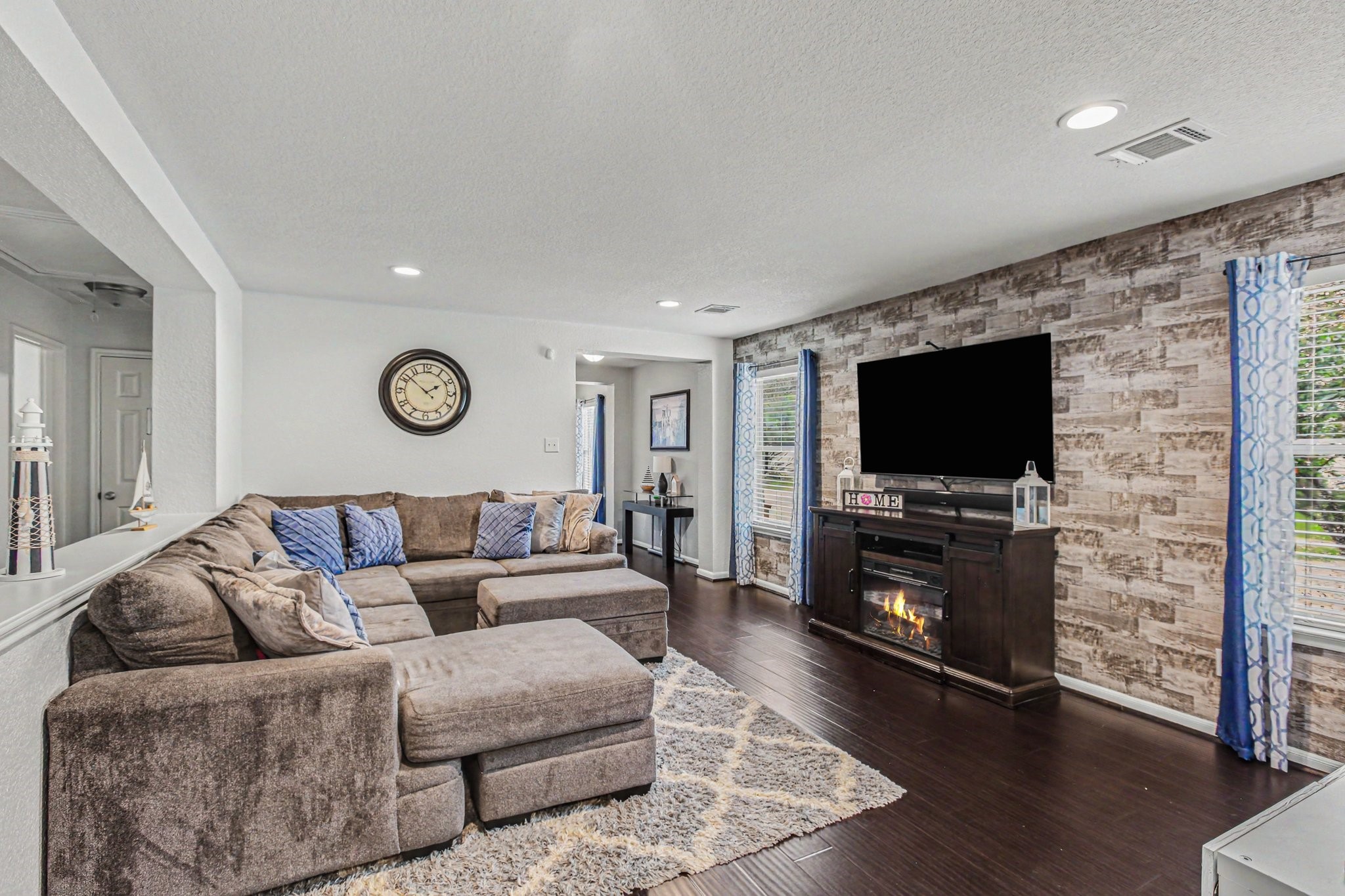 2903 Swift Brook Glen Way Spring, TX 77389 - Photo 6 of 30 Striking living room presents a stunning accent wall, large windows, and gorgeous flooring.