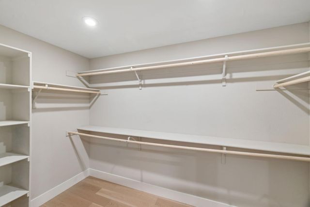 a spacious bathroom with a toilet sink double and mirror