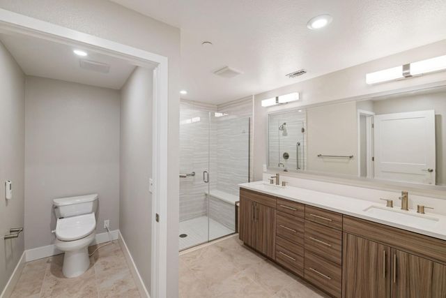 a bathroom with a double vanity sink mirror and double