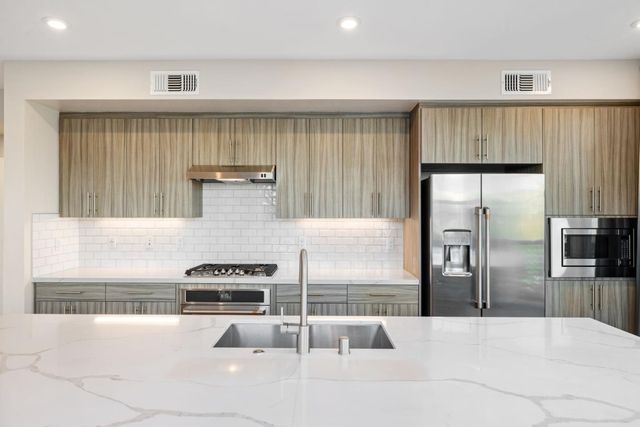 a kitchen with a refrigerator and a sink