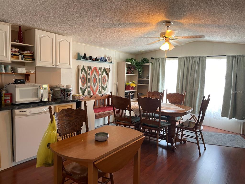 251 Patterson Road, Unit C31 Haines City, FL 33844 - Photo 11 of 16 a view of a dining room with furniture and wooden floor