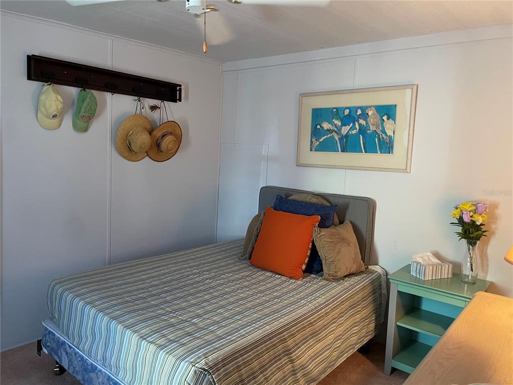 251 Patterson Road, Unit C31 Haines City, FL 33844 - Photo 12 of 16 a bedroom with a bed and a painting on the wall