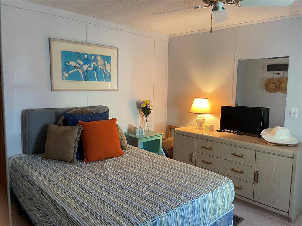 251 Patterson Road, Unit C31 Haines City, FL 33844 - Photo 14 of 16 a bedroom with a bed and a desk