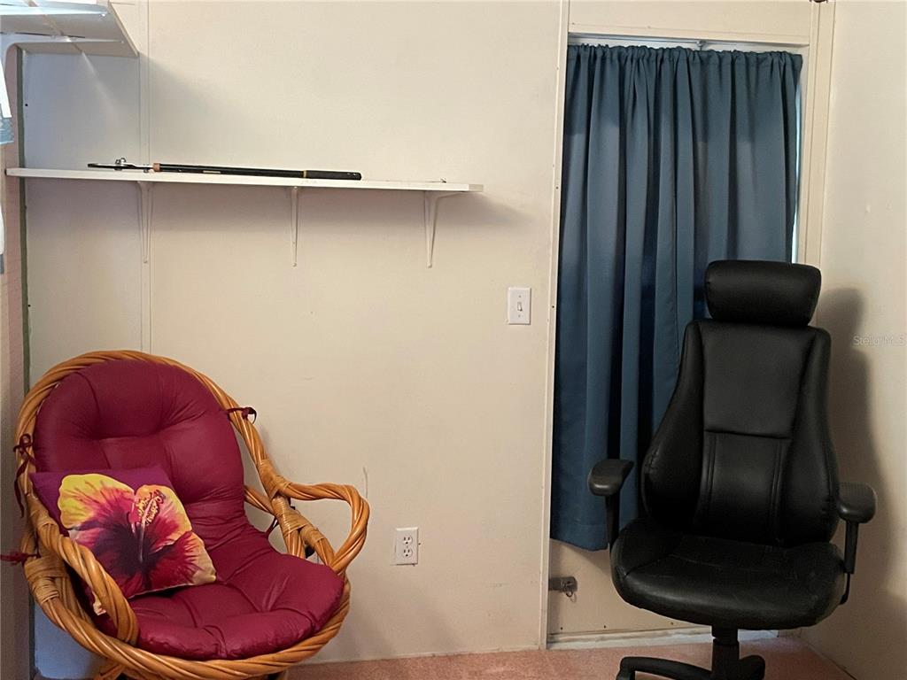 251 Patterson Road, Unit C31 Haines City, FL 33844 - Photo 15 of 16 a room with a chair and potted plant