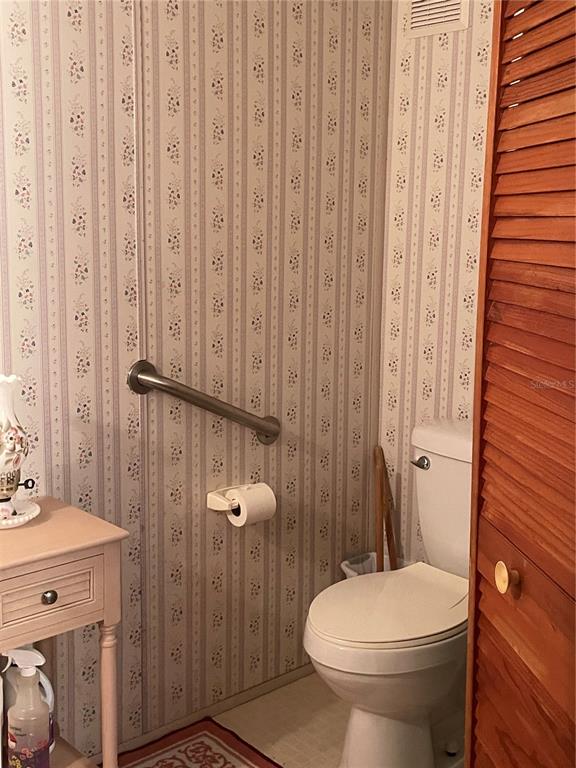 251 Patterson Road, Unit C31 Haines City, FL 33844 - Photo 16 of 16 a bathroom with a toilet a sink and shower