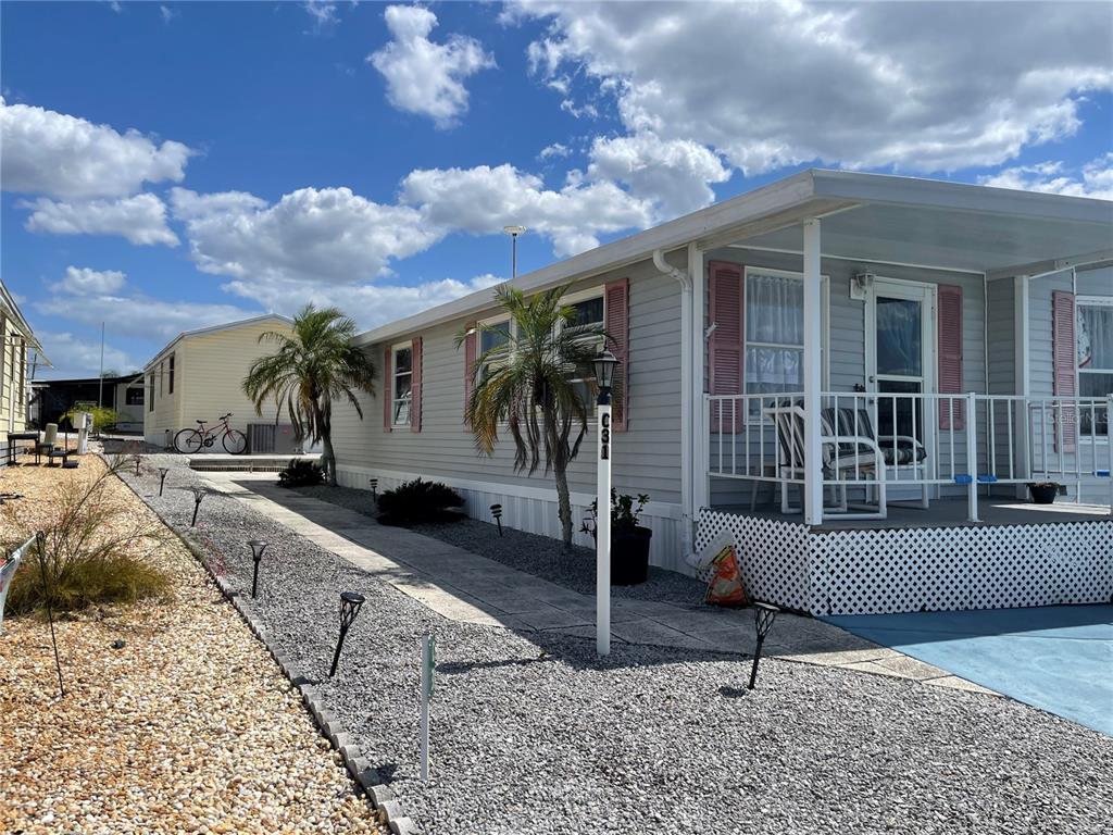 251 Patterson Road, Unit C31 Haines City, FL 33844 - Photo 2 of 16 a view of a house with backyard and sitting area