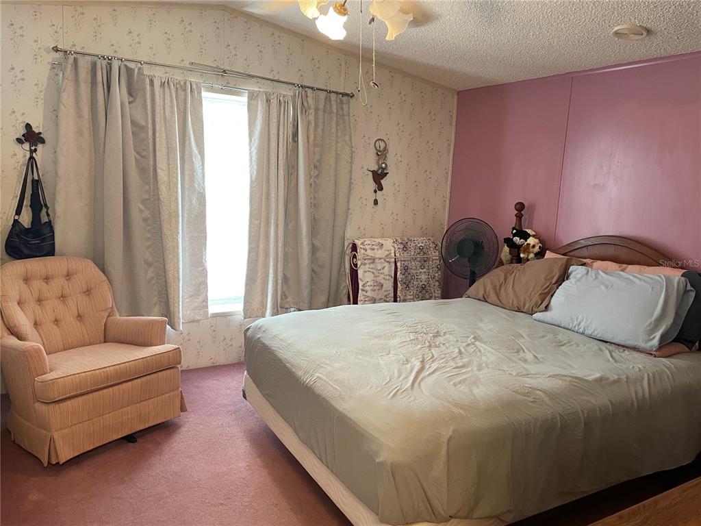 251 Patterson Road, Unit C31 Haines City, FL 33844 - Photo 5 of 16 a bedroom with a bed and a couch