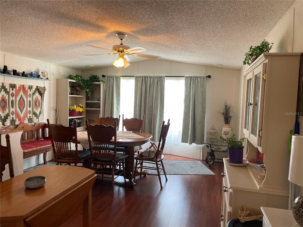 251 Patterson Road, Unit C31 Haines City, FL 33844 - Photo 10 of 16 a view of a dining room with furniture window and wooden floor