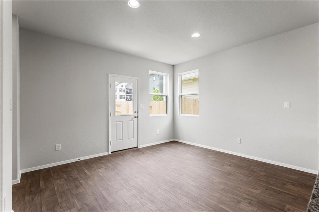 2707 Totley Road Manor, TX 78653 - Photo 14 of 39 Unfurnished room with dark wood-type flooring and recessed lighting