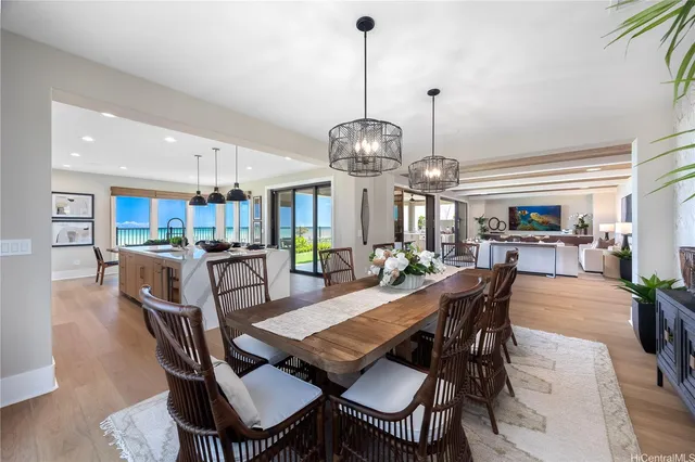 a view of a dining room and livingroom furniture a chandelier and wooden floor