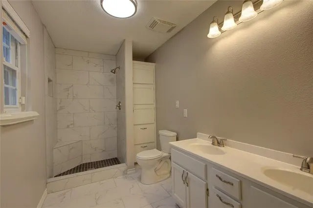 a bathroom with a sink toilet and shower