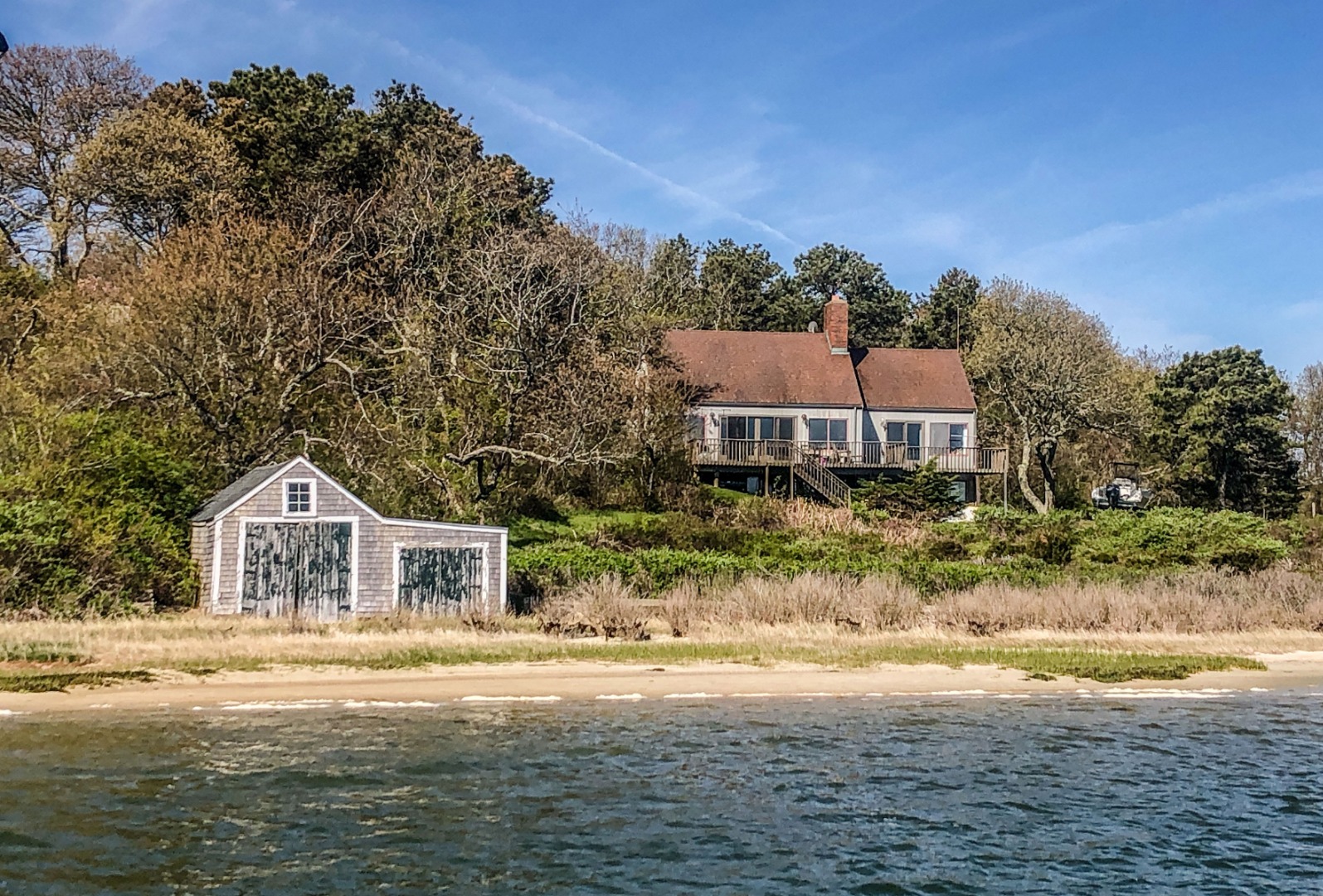 191 Katama Road Edgartown, MA 02539 - Photo 12 of 20 a front view of a house with a yard and garage