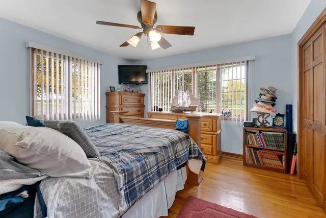 a bedroom with a bed and a large window