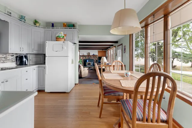a view of a dining room with furniture and a chandelier