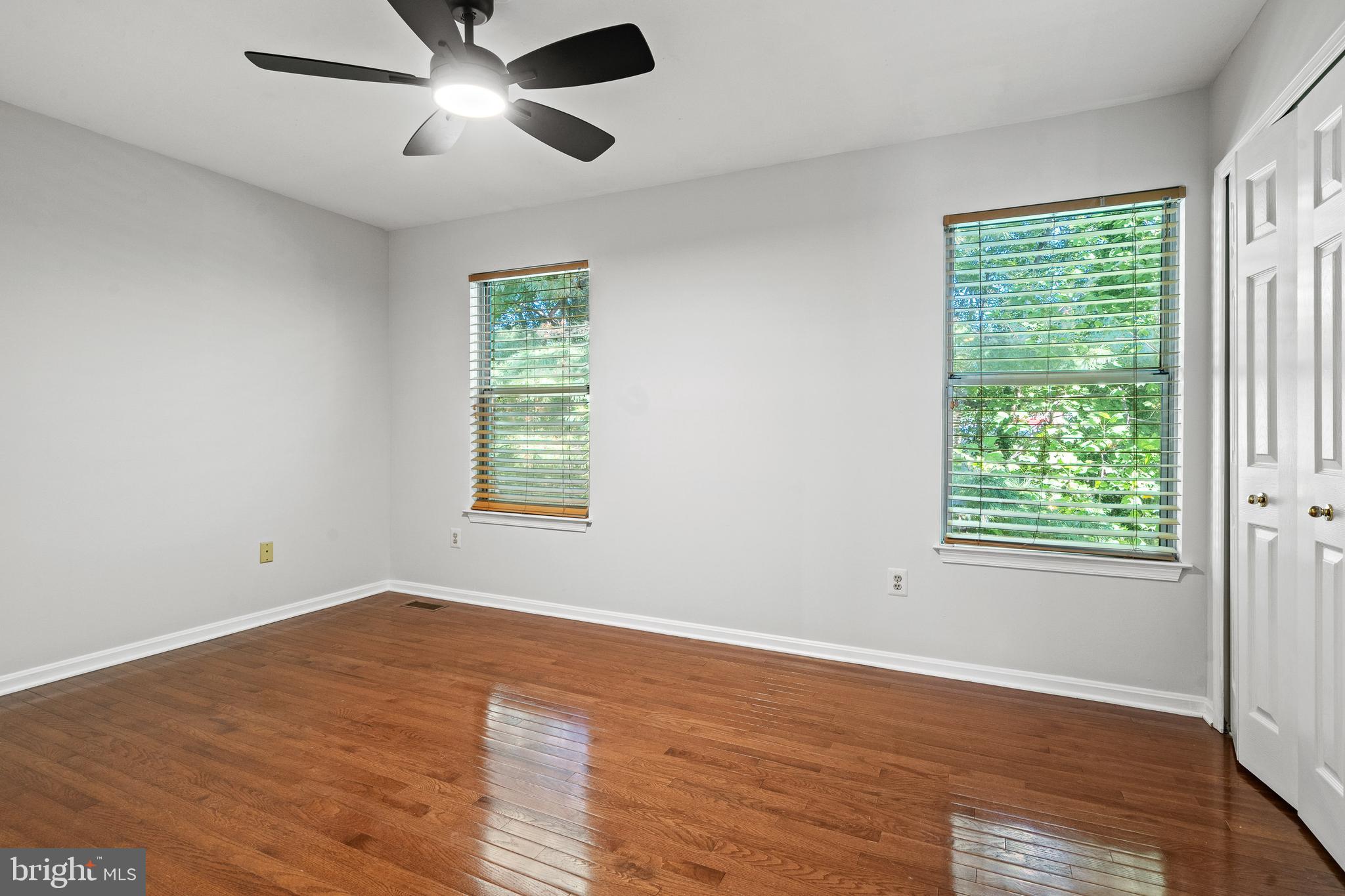 1132 Ingate Road, Unit 1132 Baltimore, MD 21227 - Photo 11 of 35 a view of an empty room with wooden floor and a window
