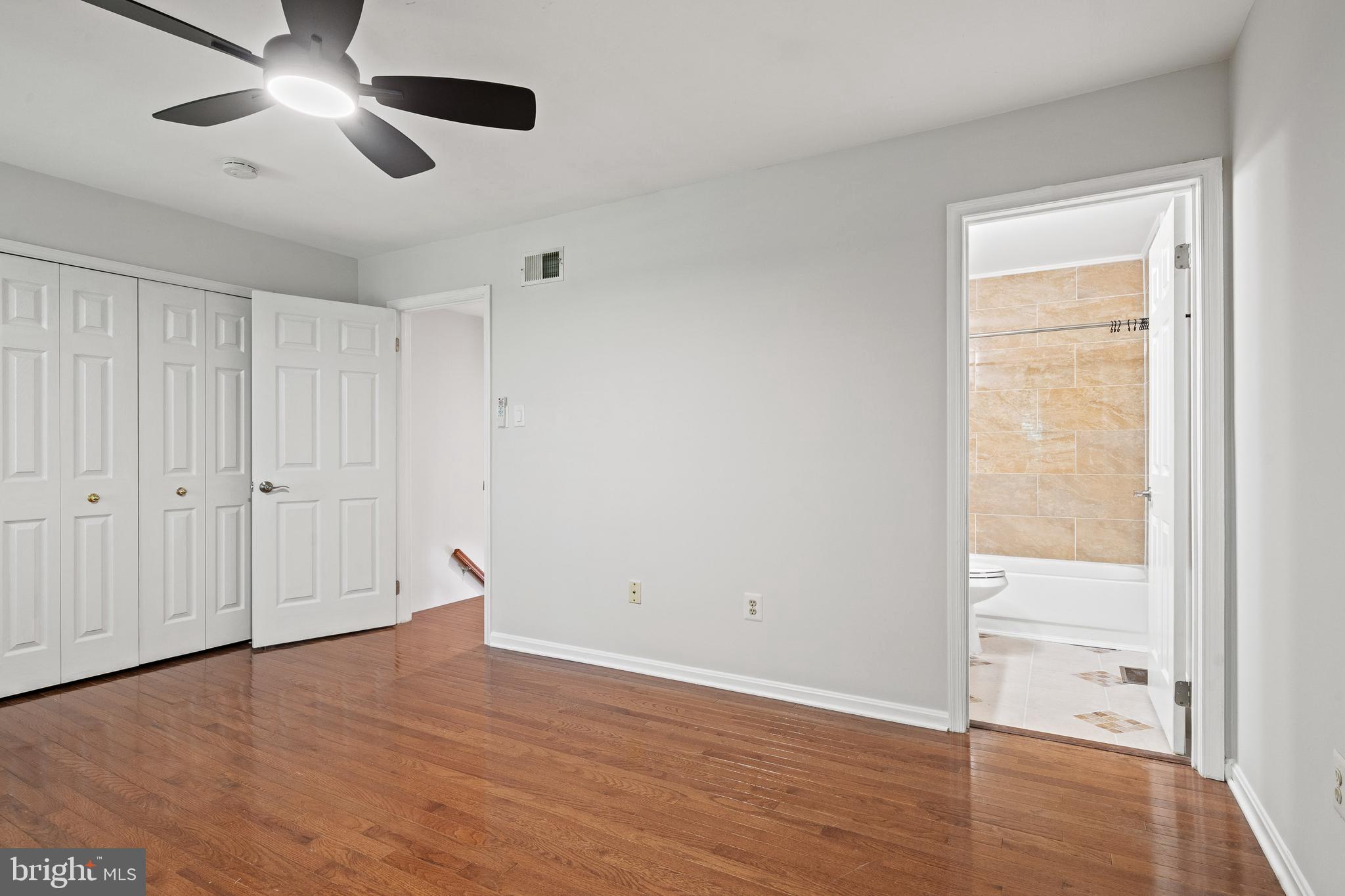 1132 Ingate Road, Unit 1132 Baltimore, MD 21227 - Photo 12 of 35 an empty room with wooden floor and windows