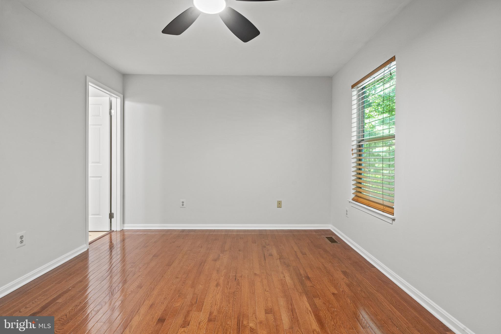 1132 Ingate Road, Unit 1132 Baltimore, MD 21227 - Photo 13 of 35 wooden floor in an empty room with a window