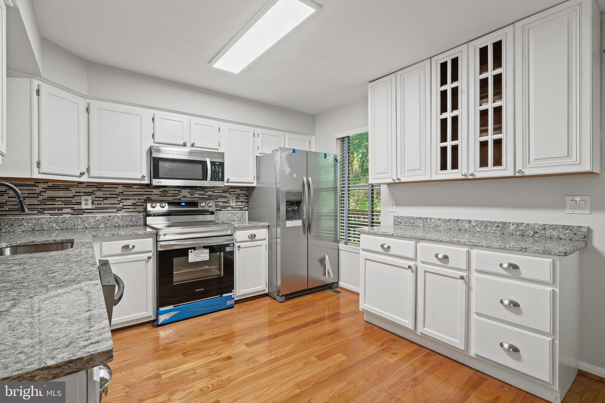 1132 Ingate Road, Unit 1132 Baltimore, MD 21227 - Photo 2 of 35 a kitchen with stainless steel appliances granite countertop a stove and a sink