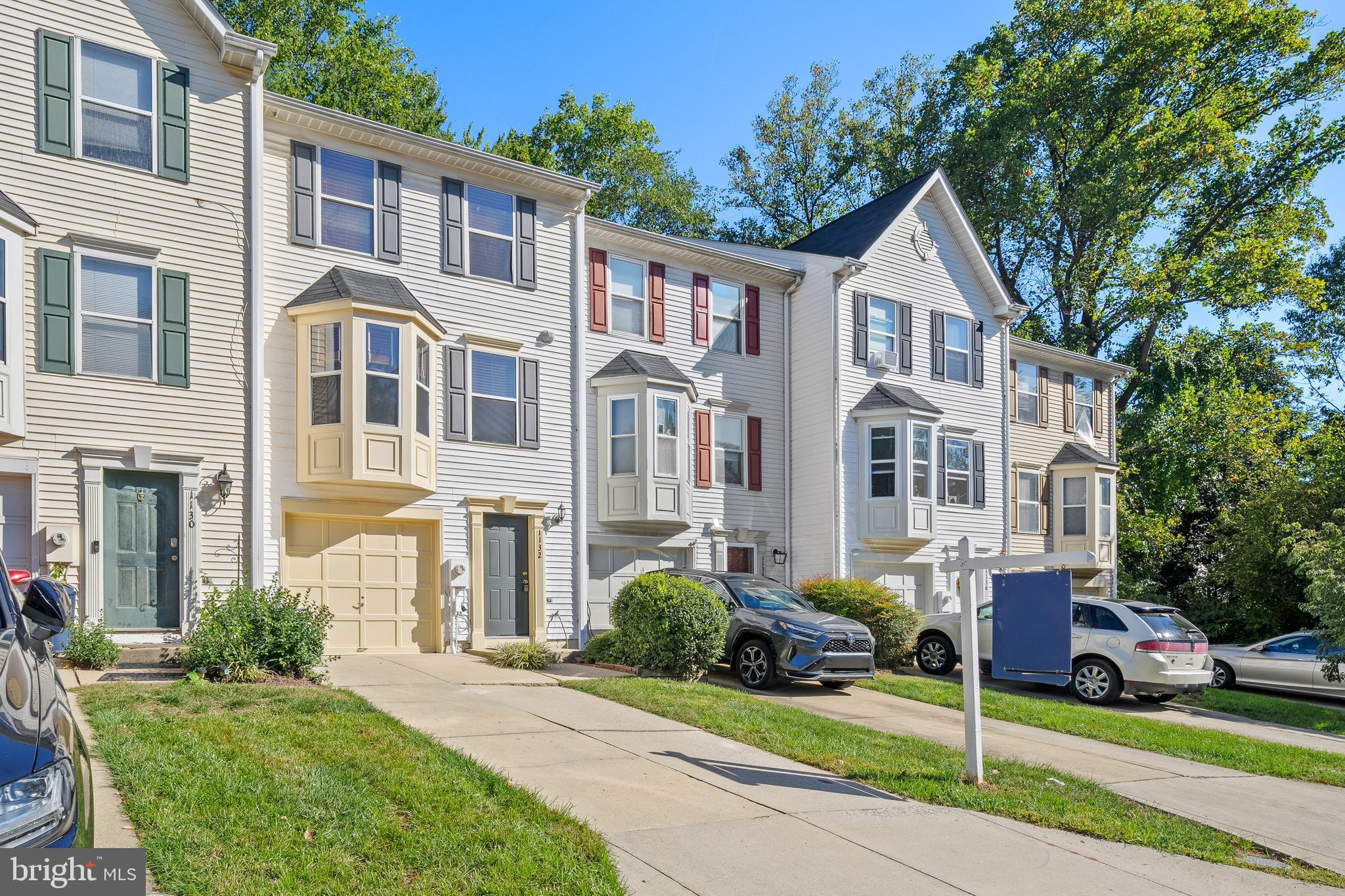 1132 Ingate Road, Unit 1132 Baltimore, MD 21227 - Photo 31 of 35 a view of a white house with a yard and plants