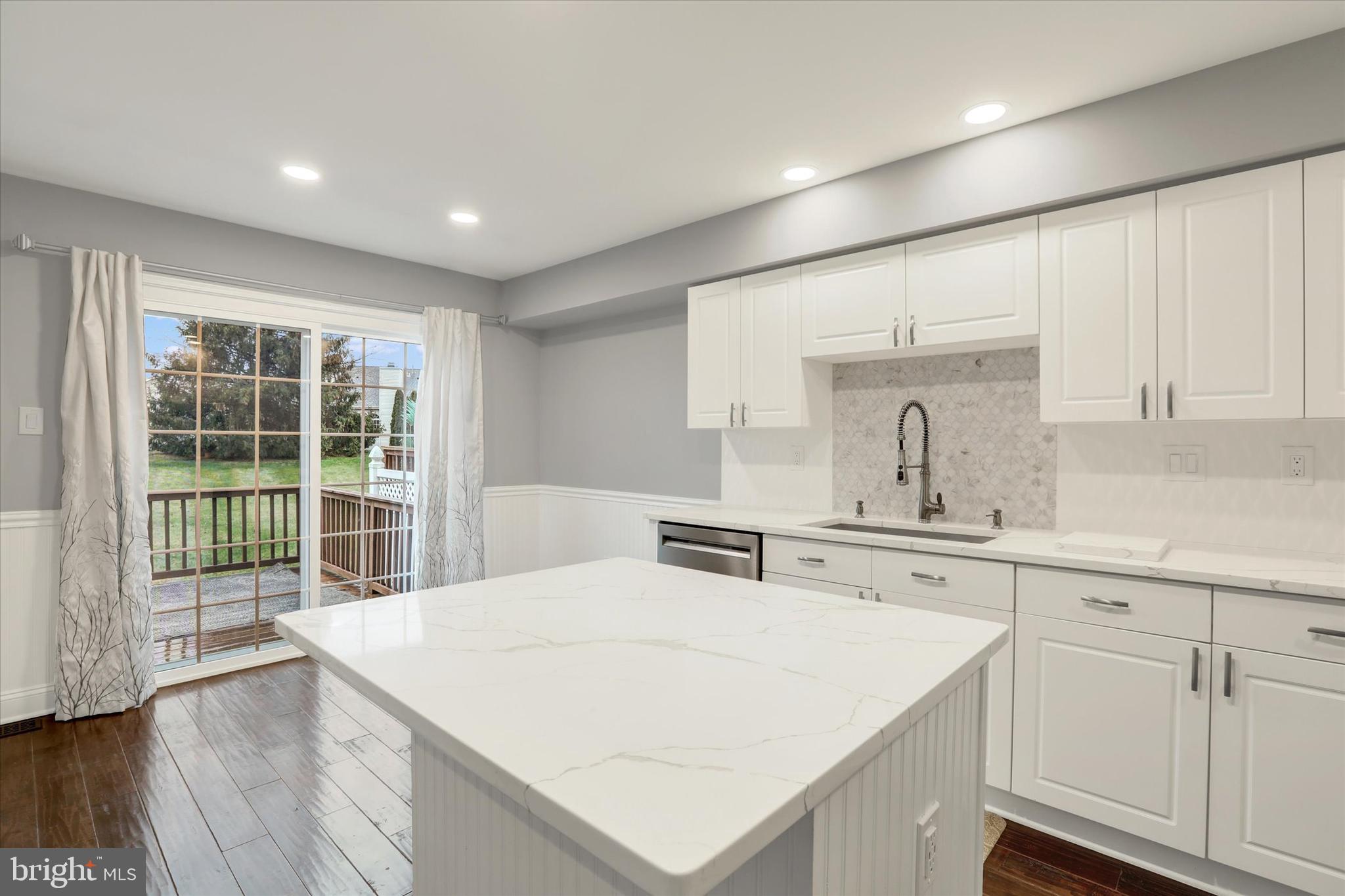 102 Julian Drive East, Unit E Warminster, PA 18974 - Photo 11 of 28 a large white kitchen with sink and cabinets