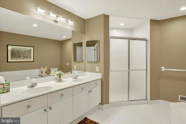a bathroom with a double vanity sink and a mirror