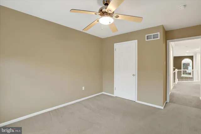 an empty room with fan and a ceiling fan