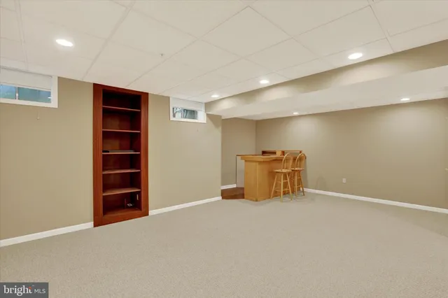 a view of an empty room with cabinet and a window