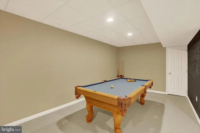 a room with pool table and windows