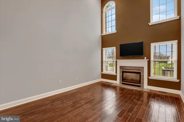 a view of a livingroom with a fireplace and wooden floor