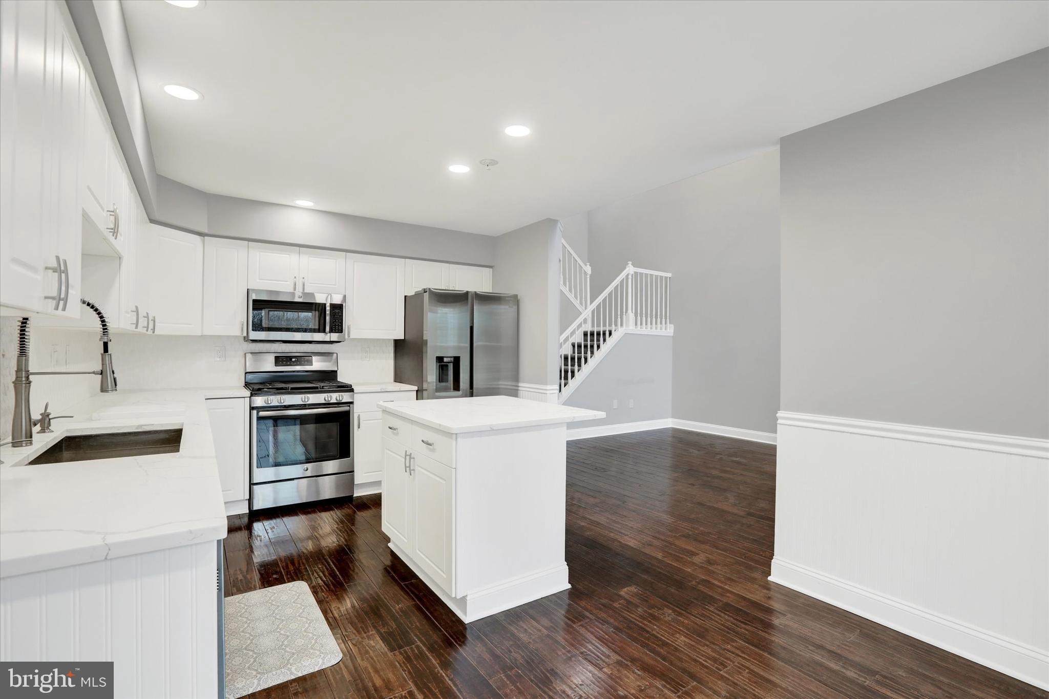 102 Julian Drive East, Unit E Warminster, PA 18974 - Photo 10 of 28 a kitchen with white cabinets and stainless steel appliances