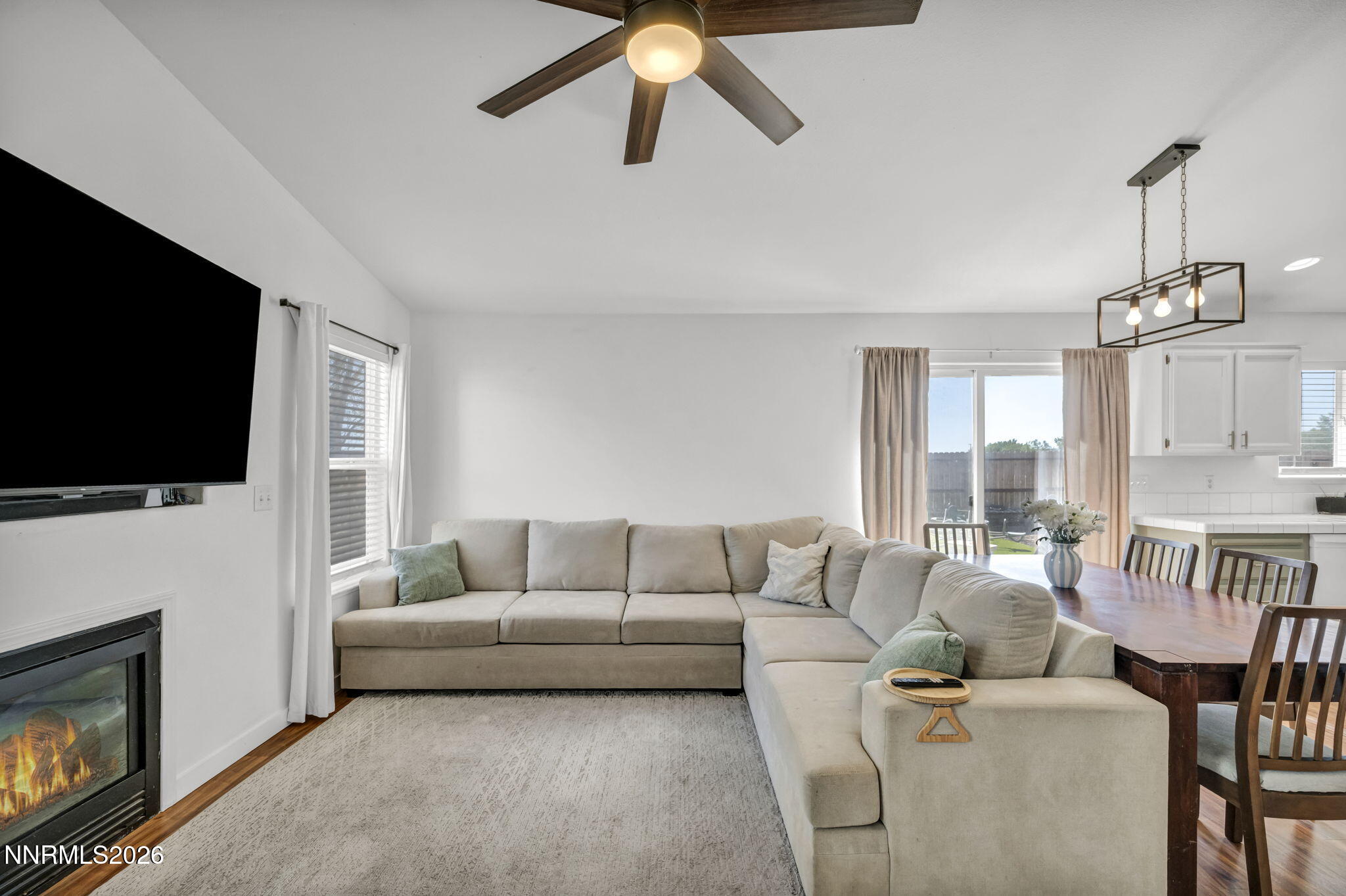 111 Relief Springs Road Fernley, NV 89408 - Photo 11 of 30 a living room with furniture a flat screen tv and a fireplace