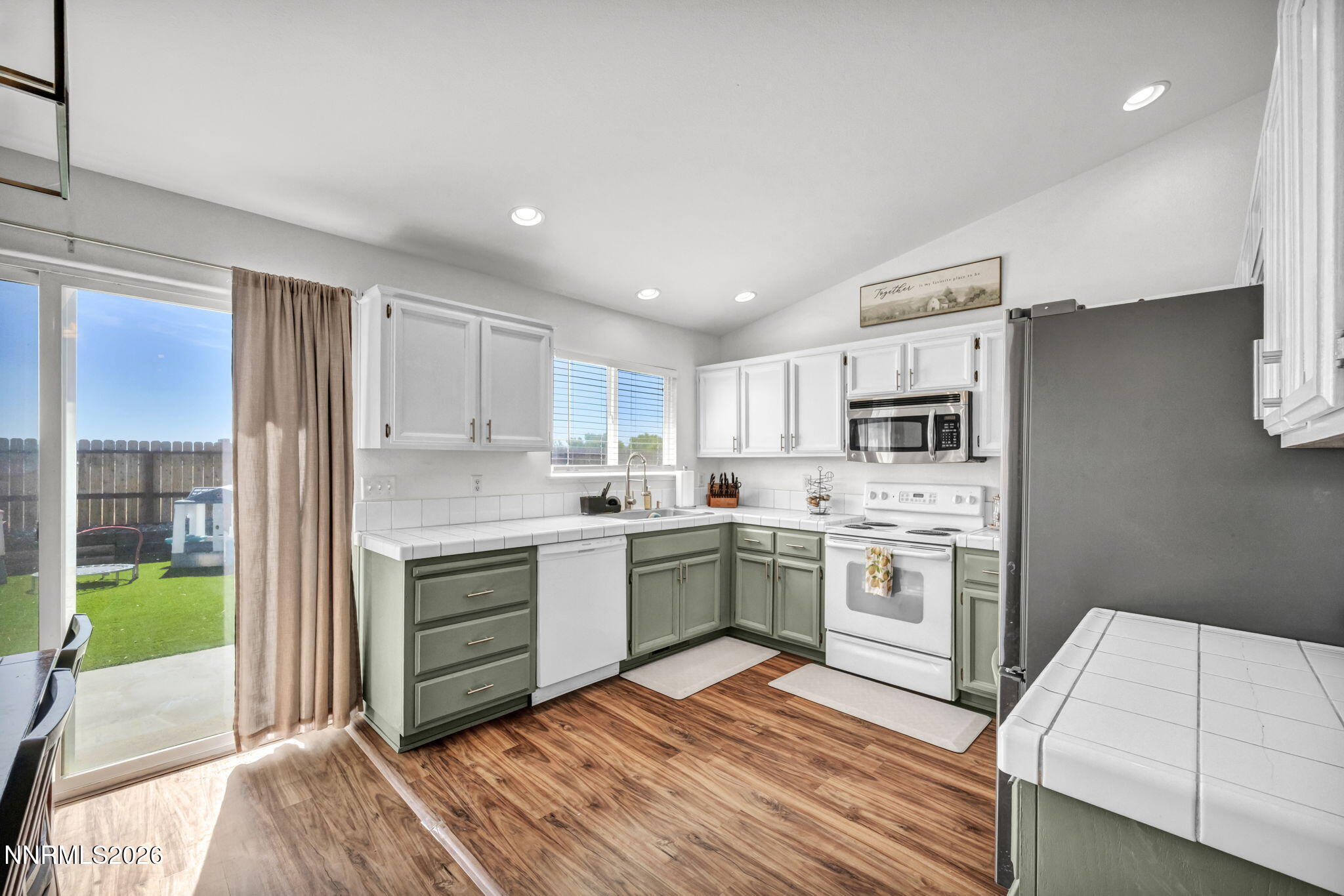 111 Relief Springs Road Fernley, NV 89408 - Photo 13 of 30 a kitchen with a stove refrigerator sink and microwave