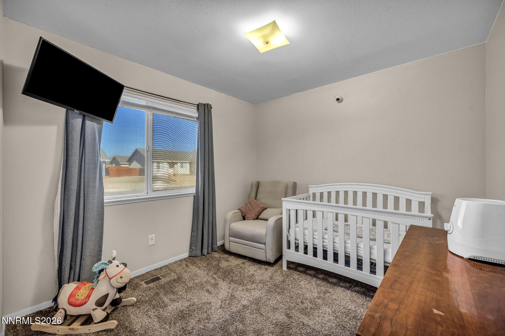 111 Relief Springs Road Fernley, NV 89408 - Photo 21 of 30 a bedroom with furniture and a window