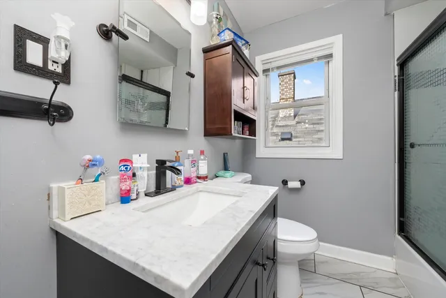 a bathroom with a sink a vanity and a toilet