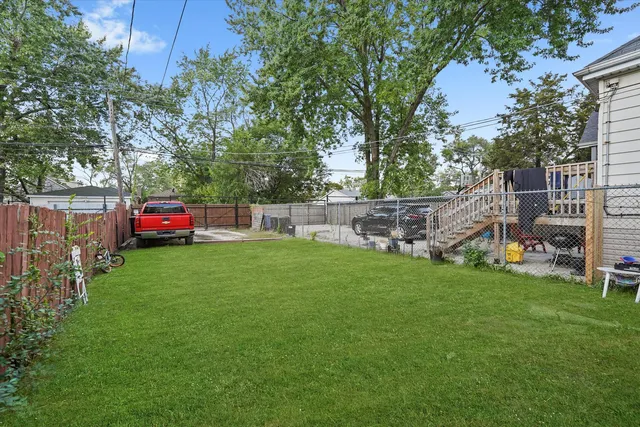 a view of a house with a backyard and a patio