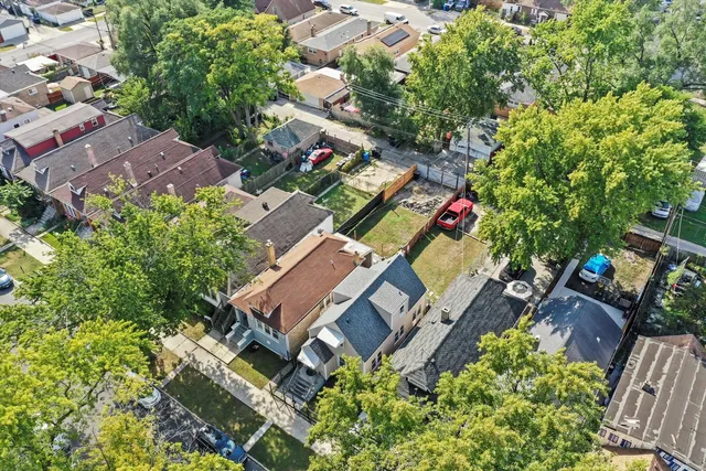 an aerial view of multiple houses with yard