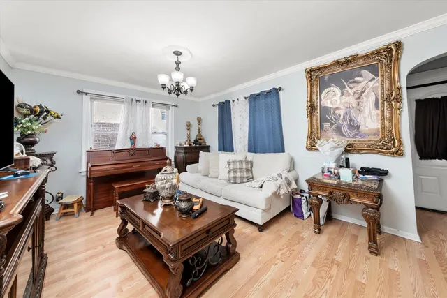 a living room with furniture a piano and a flat screen tv