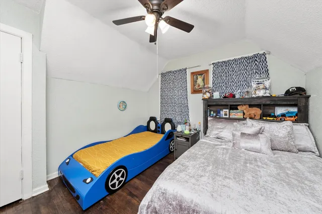 a room with pool table and ceiling fan
